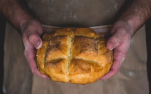 Daily bread - hands holding a loaf of bread